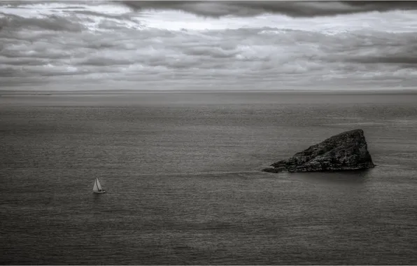 Sea, clouds, stones, shore, sailboat, horizon