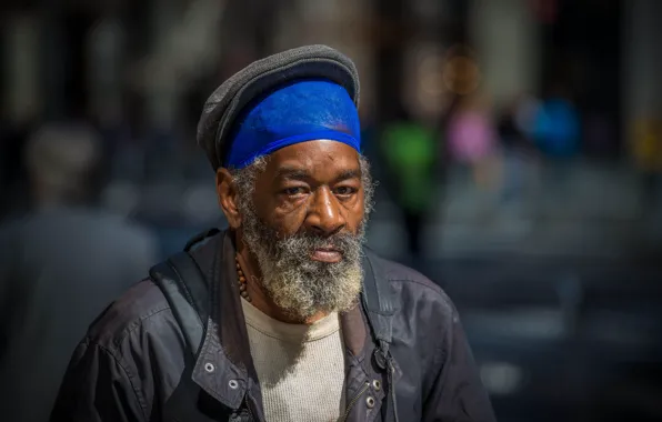 Man, bearded, direct gaze, homeless