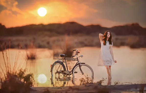 Girl, the sun, bike, in the water