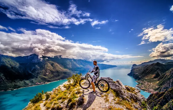 The sky, clouds, mountains, the city, rider, peak, solar, mountain bike