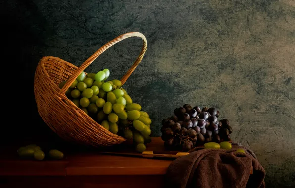 The dark background, table, grapes, knife, fabric, fruit, still life, basket