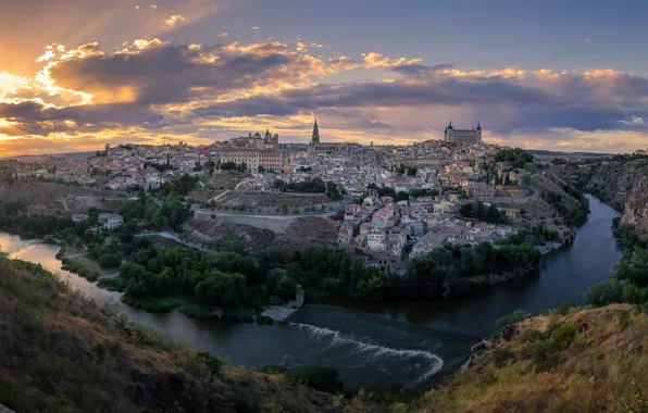 Picture the sky, the sun, clouds, landscape, sunset, the city, river, rocks