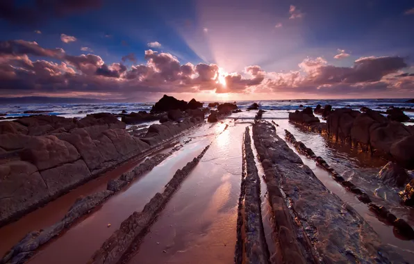 Sea, the sun, clouds, stones, shore