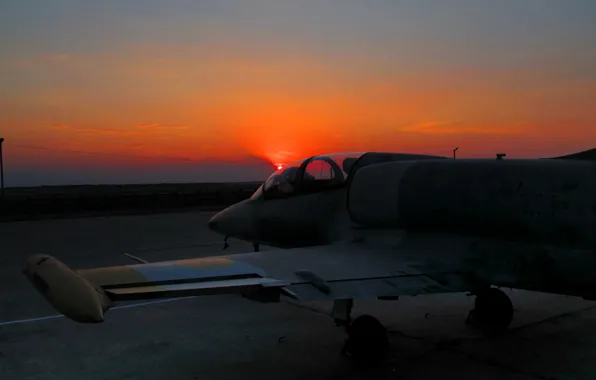 Picture sunset, the plane, L-39, at the airport