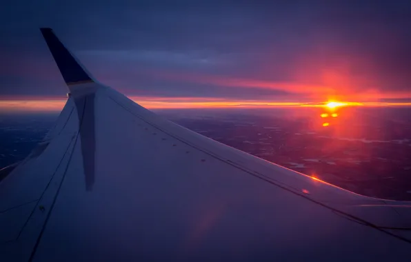 The sun, horizon, the plane, the view from the top, wing