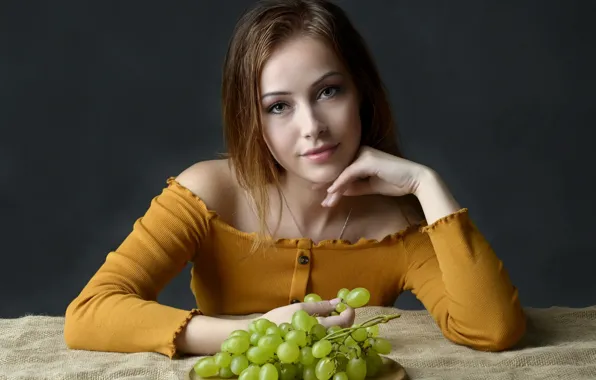 Picture girl, grapes, brown hair, sweater