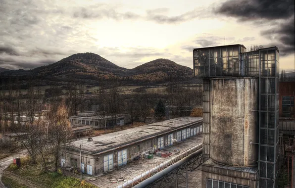 The sky, trees, mountains, tower, warehouses