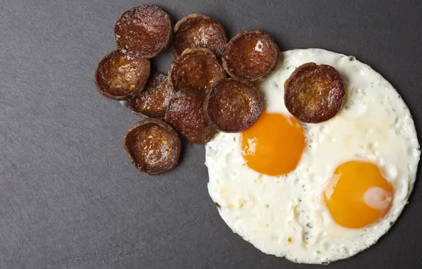 Eggs, scrambled eggs, grey background, circles, sausage, eggs, fried