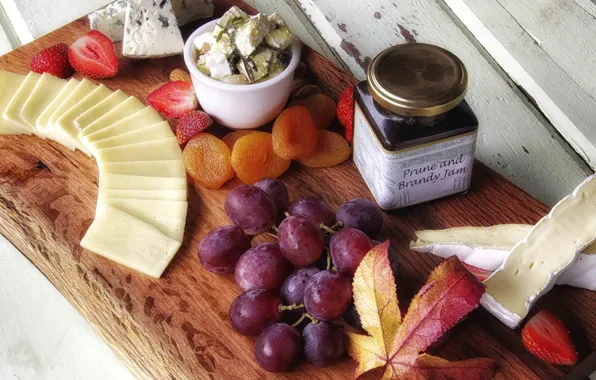Picture cheese, strawberry, grapes, dried apricots