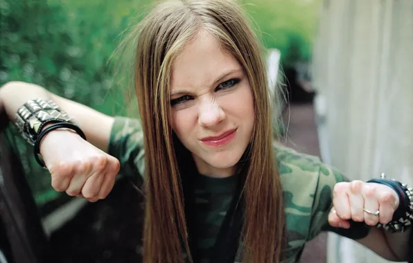 Girl, Avril Lavigne, Rock singer, shows fists, wrinkled nose