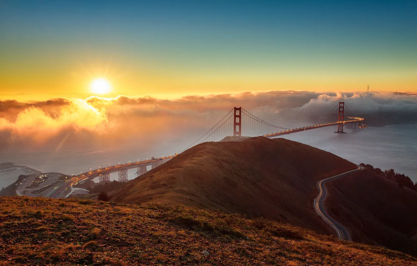 Photo wallpaper road, the sky, the sun, rays, light, mountains, bridge, the city