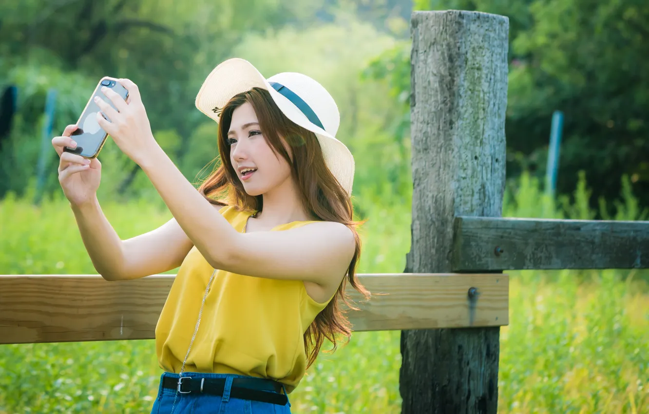 Photo wallpaper girl, the fence, hat, Asian, cutie, bokeh, smartphone, selfie