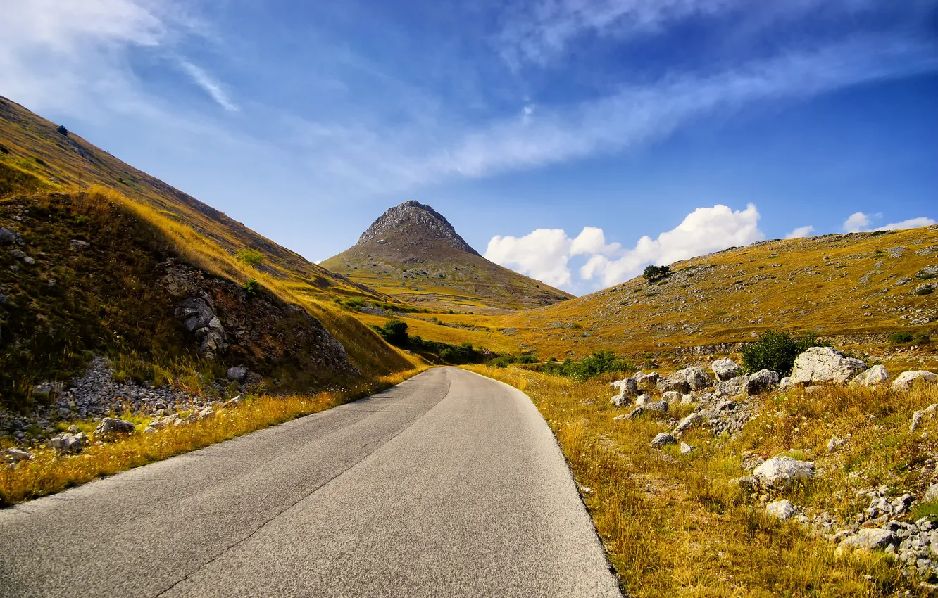 Photo wallpaper road, autumn, the sky, grass, mountains, stones, slope