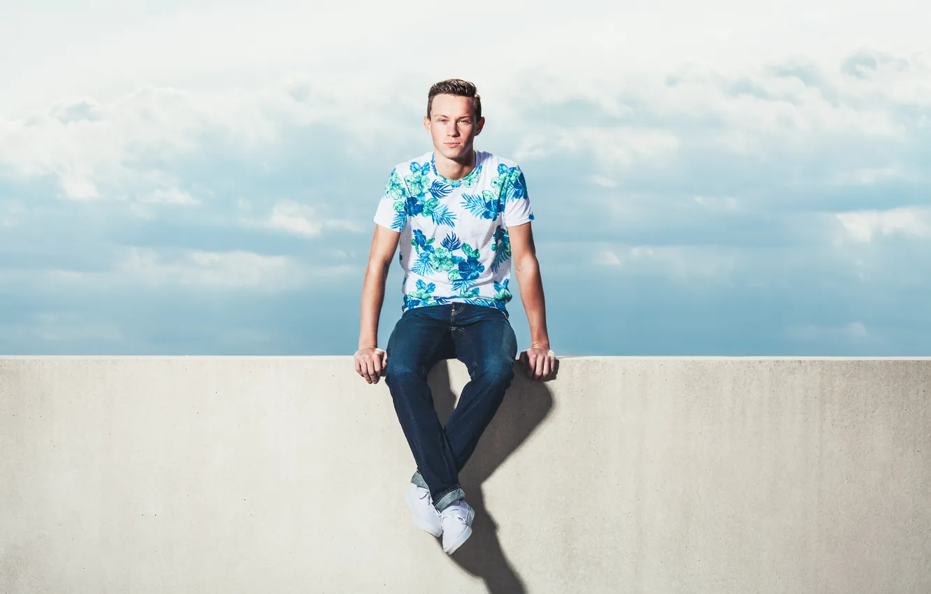 Photo wallpaper clouds, wall, shadow, male, sitting, direct look