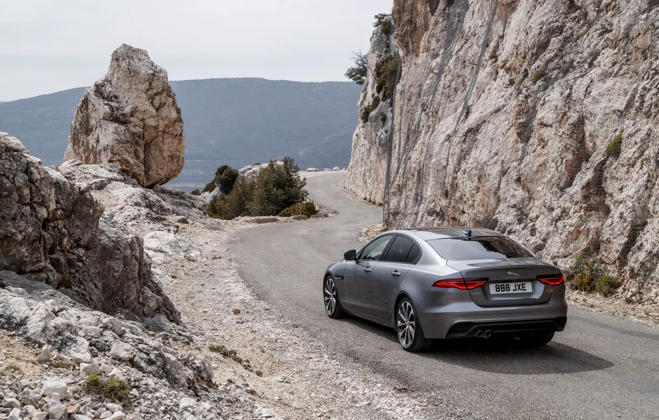 Photo wallpaper road, mountains, rocks, Jaguar, back, 2020, gray-silver, Jaguar XE
