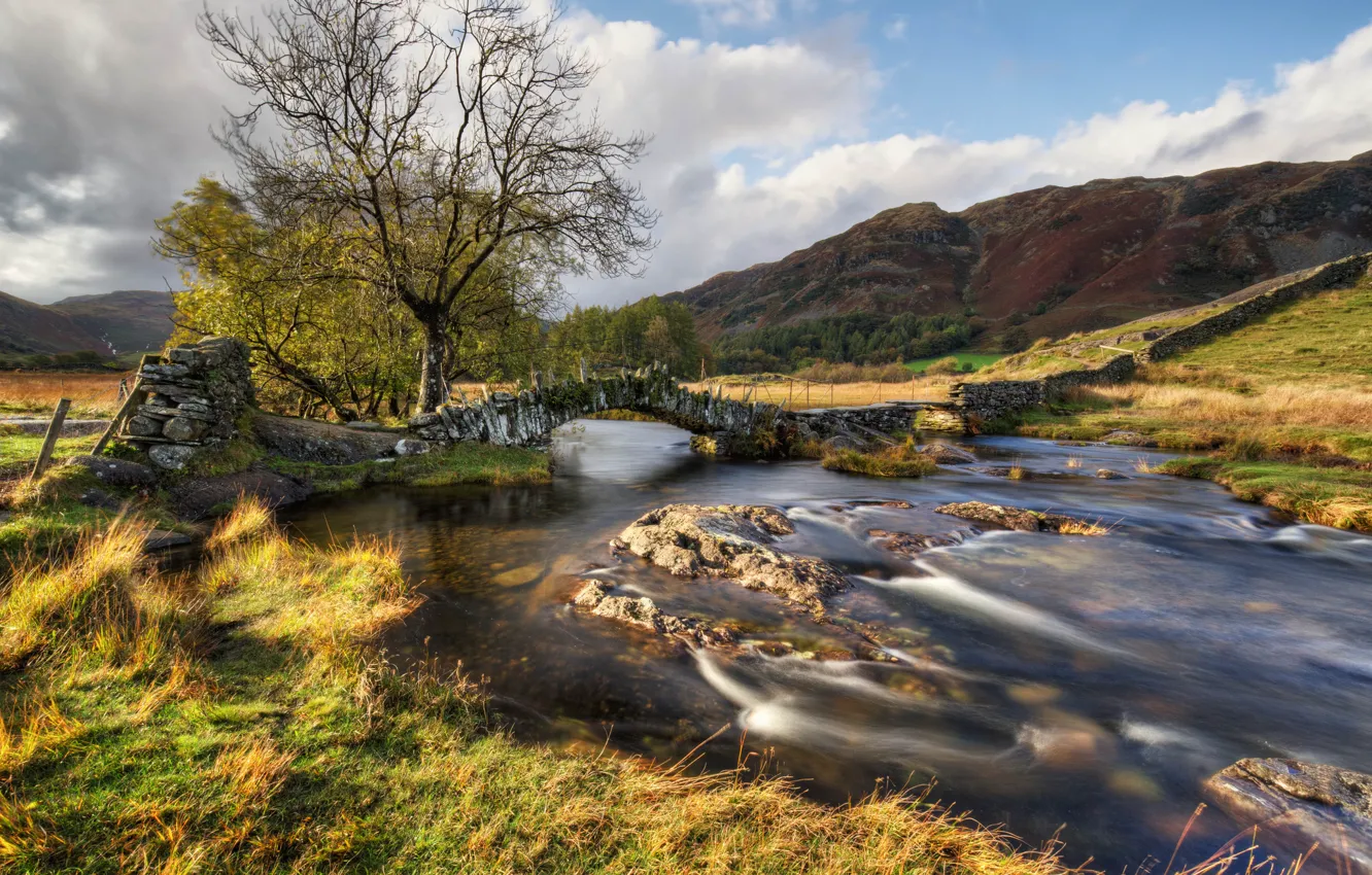 Photo wallpaper autumn, the sky, grass, clouds, bridge, river, stones, hills