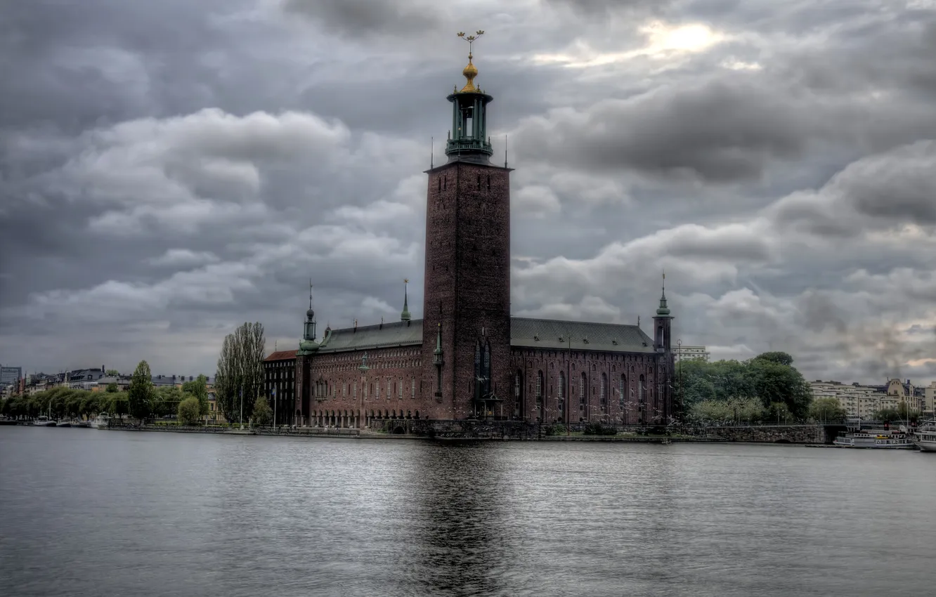 Photo wallpaper clouds, river, overcast, the building, tower, Sweden, promenade, Stockholm
