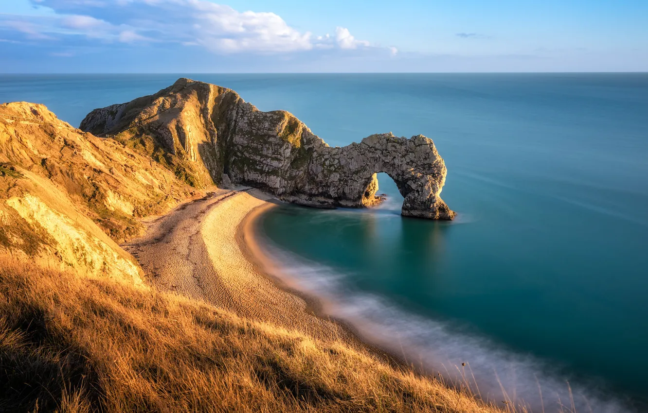Photo wallpaper sea, beach, grass, clouds, light, rocks, shore, slope