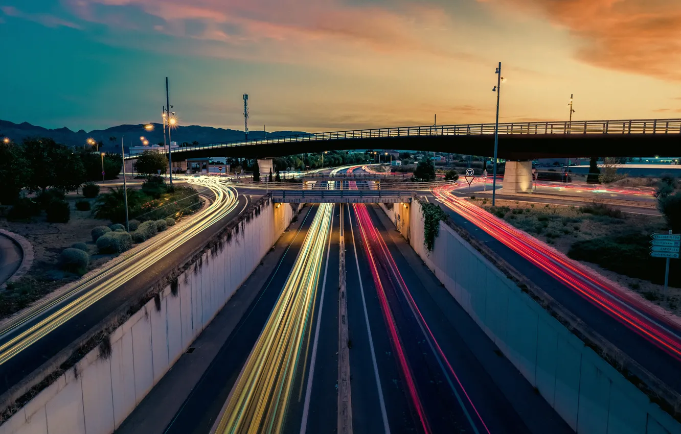 Photo wallpaper road, light, sunset, mountains, bridge, the city, lights, movement