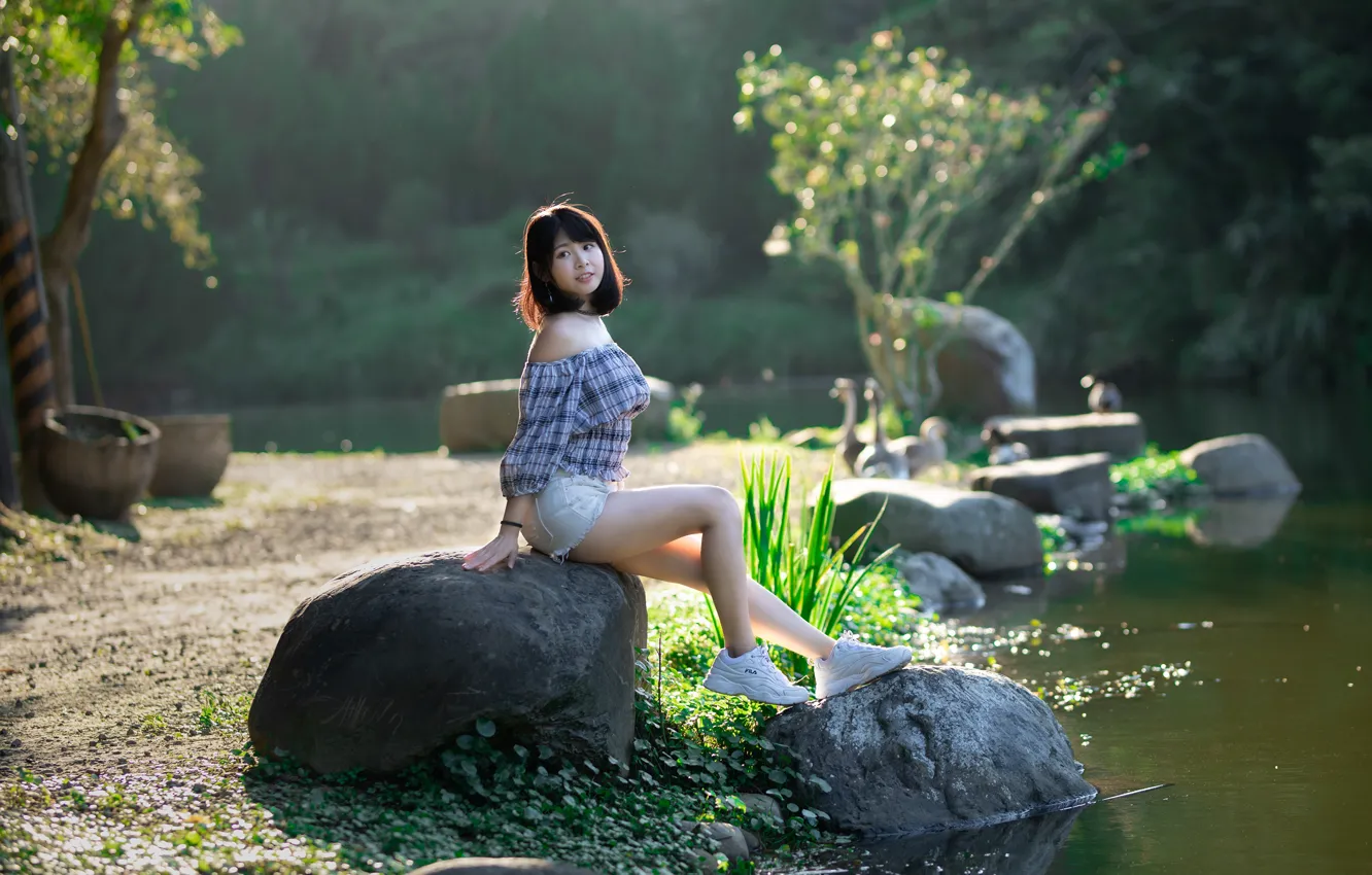 Photo wallpaper the sun, trees, pose, river, stones, model, shorts, portrait