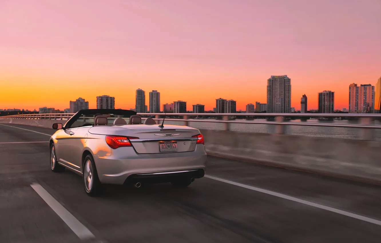 Photo wallpaper the sky, sunset, the city, silver, the evening, Chrysler, convertible, in motion