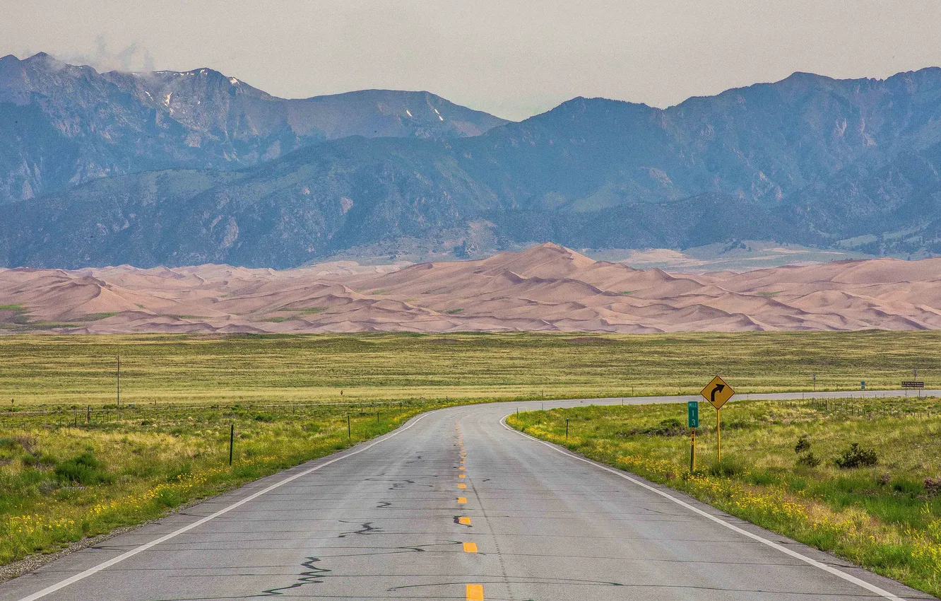 Photo wallpaper road, sand, field, the sky, grass, mountains