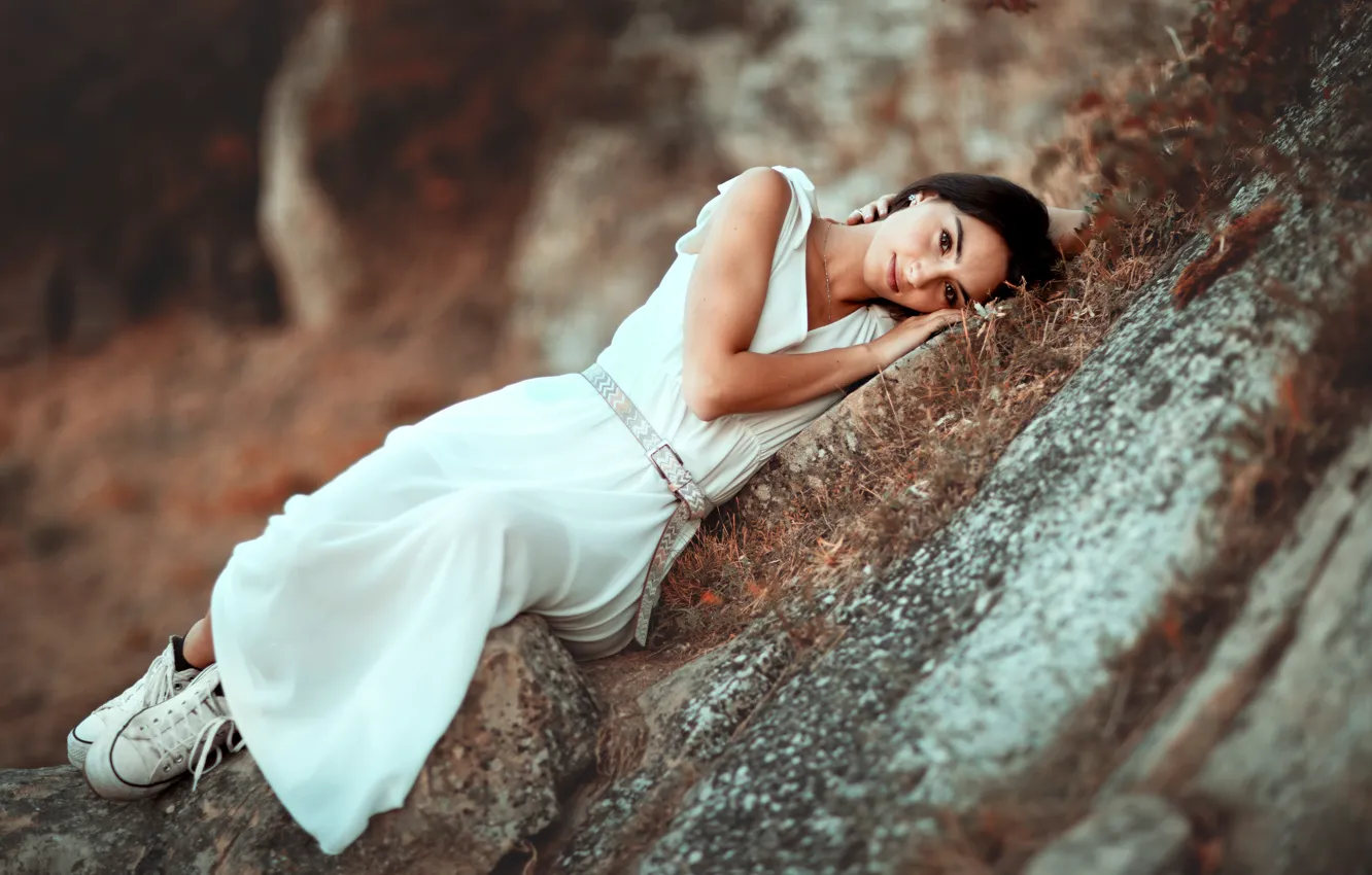 Photo wallpaper grass, look, girl, mountains, nature, pose, stones, rocks