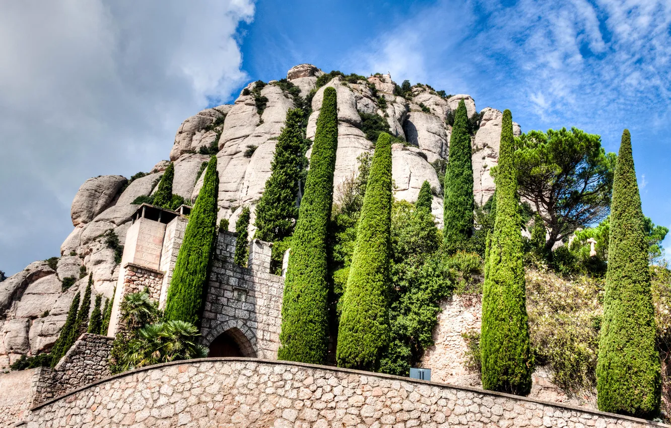 Photo wallpaper the sky, clouds, trees, mountains, Spain, the monastery, Catalonia, Montserrat