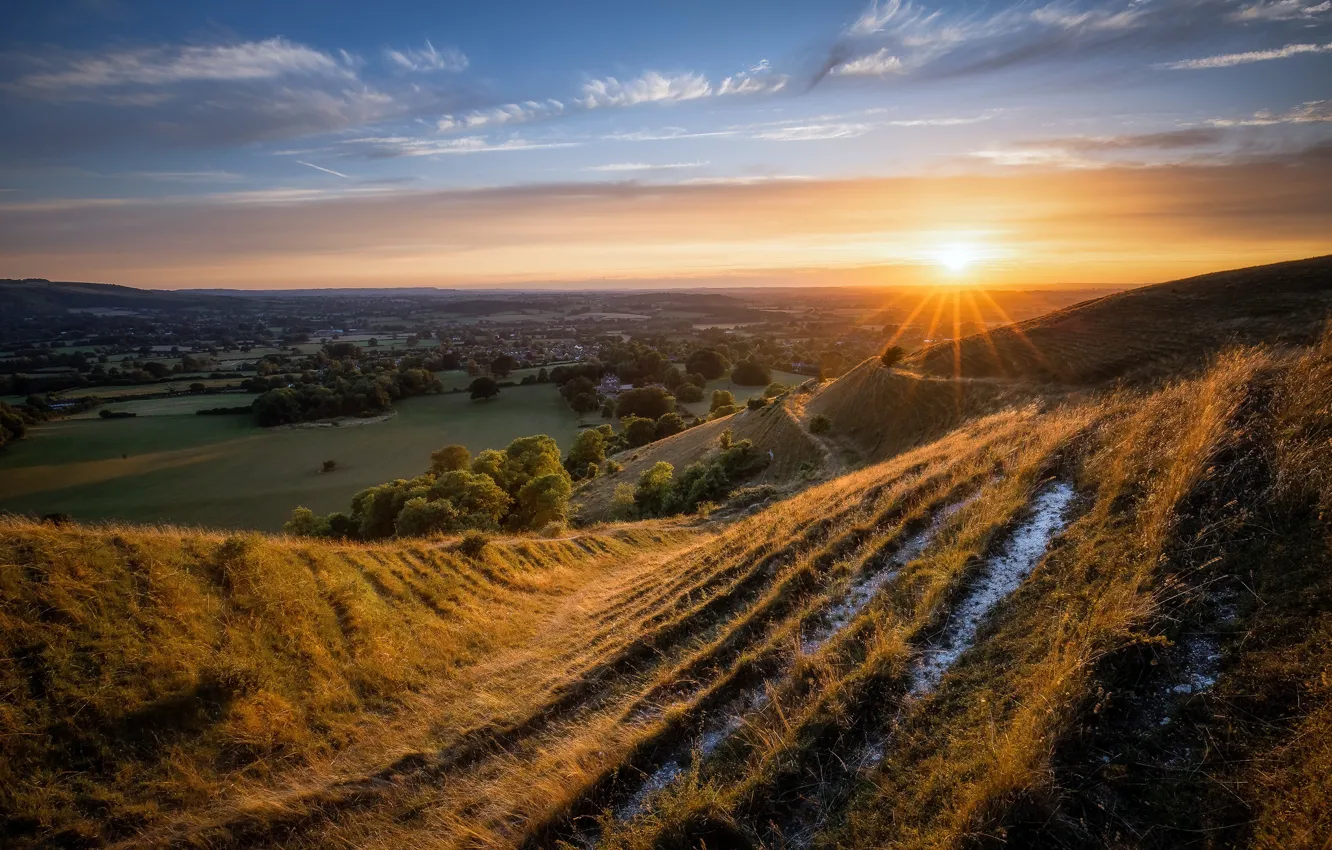 Photo wallpaper grass, the sun, sunset, hills, settlement, province