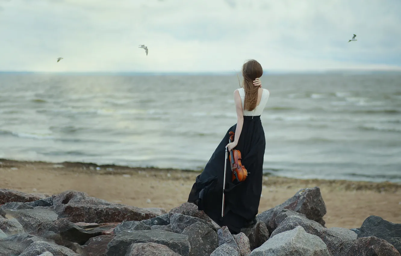 Photo wallpaper sea, beach, the sky, girl, clouds, pose, stones, overcast