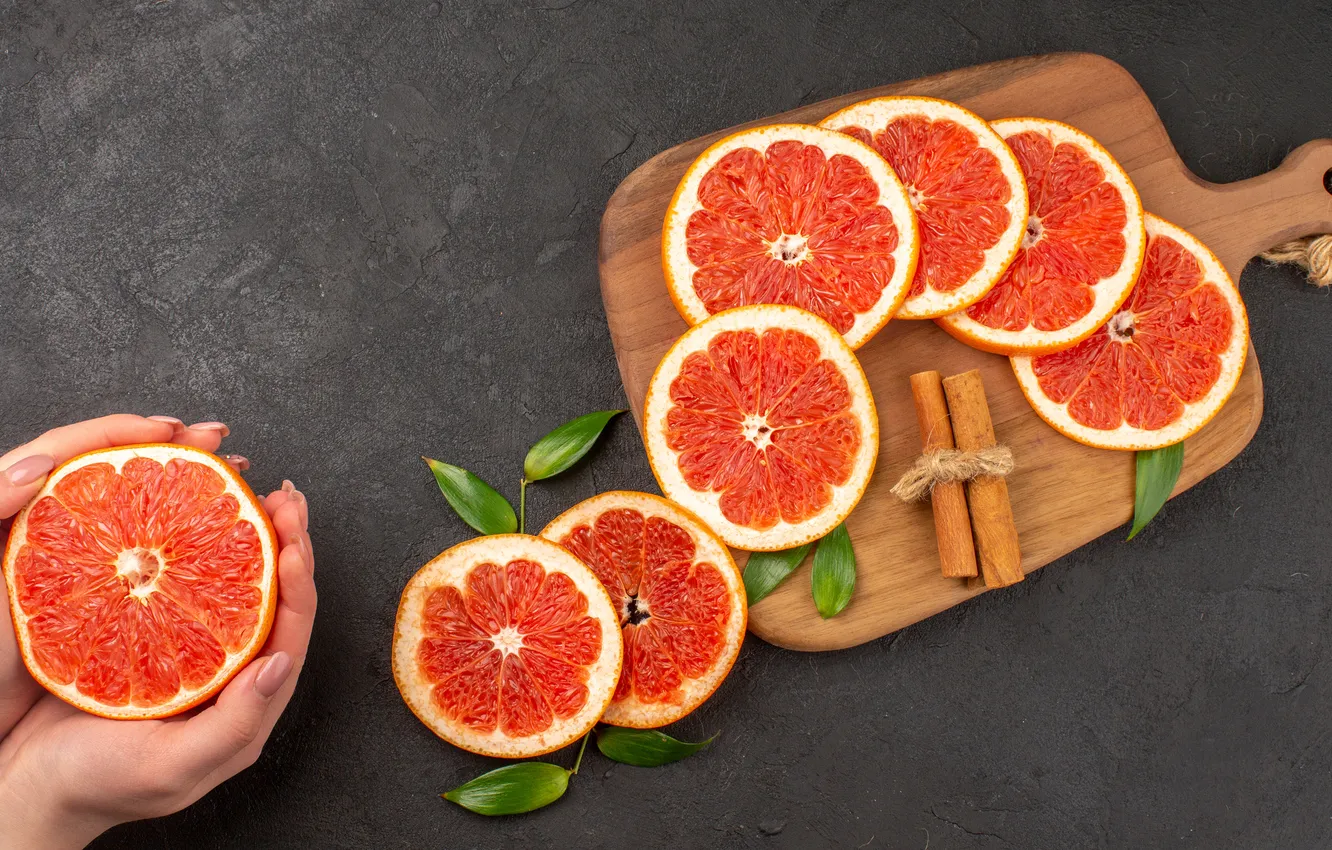 Photo wallpaper leaves, orange, hands, fruit, cinnamon, grey background, grapefruit, slices