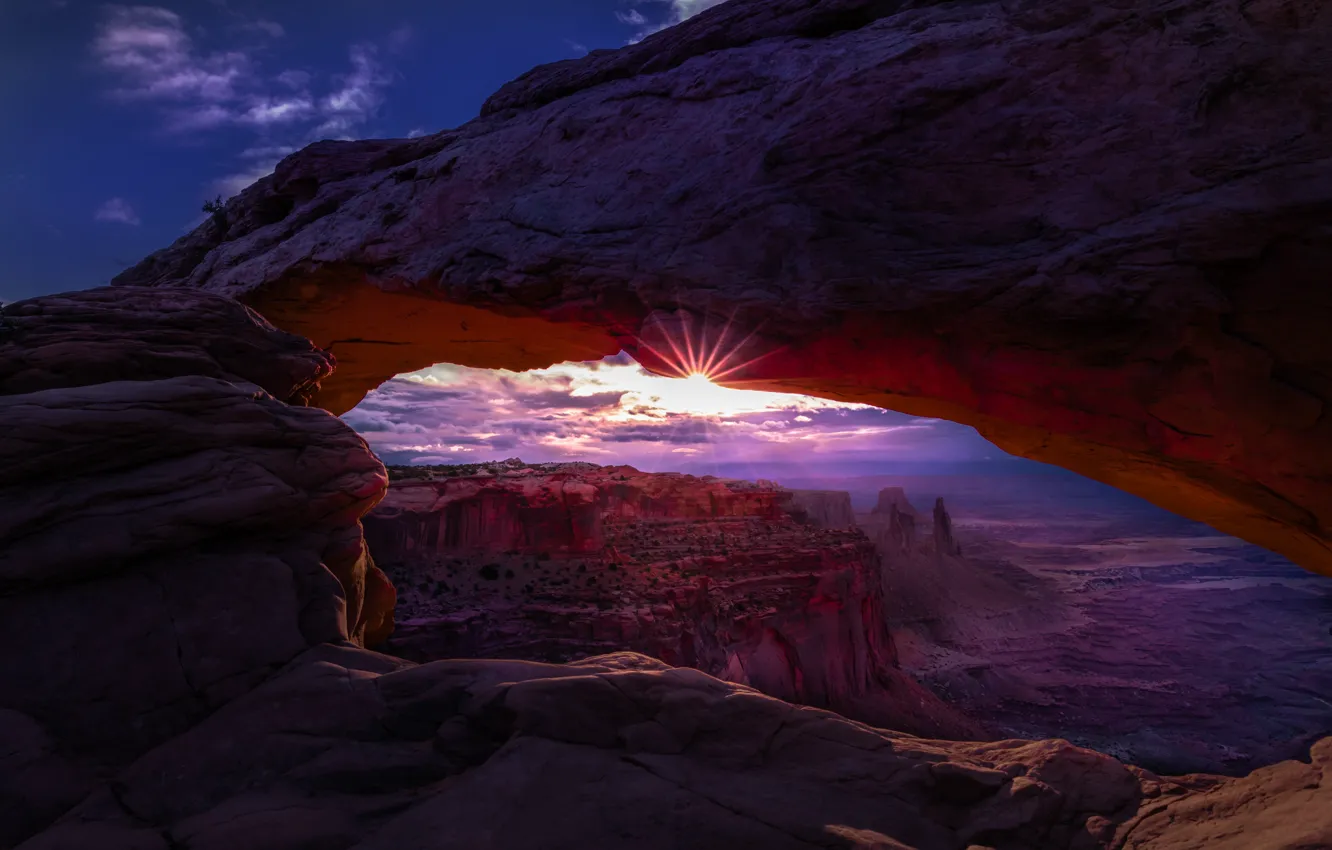 Photo wallpaper purple, the sun, clouds, rays, light, mountains, fog, stones