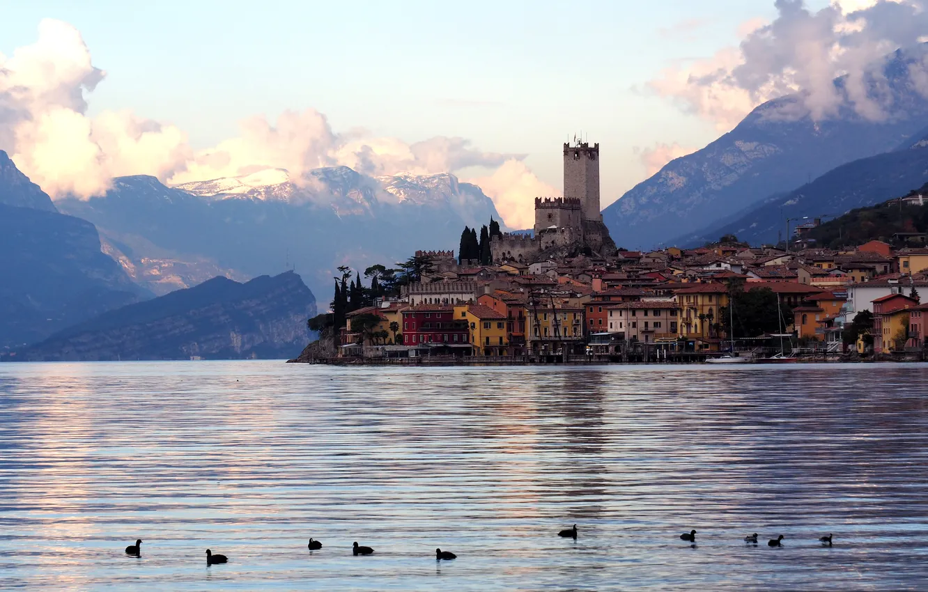 Photo wallpaper clouds, light, mountains, fog, castle, bird, shore, tops