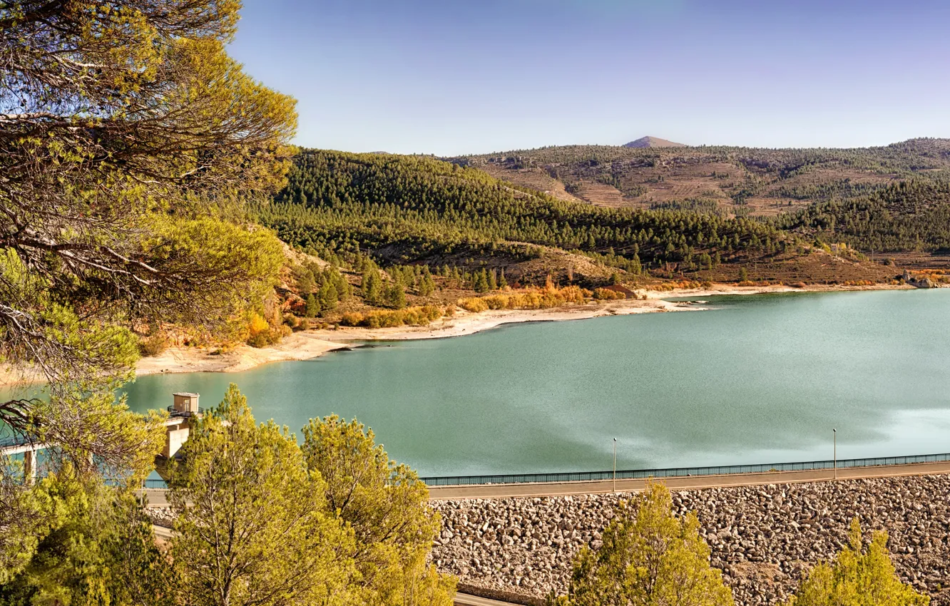 Photo wallpaper road, autumn, the sky, the sun, trees, river, stones, hills