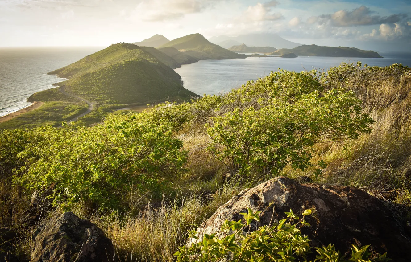 Photo wallpaper road, sea, the sky, grass, the sun, clouds, mountains, stones