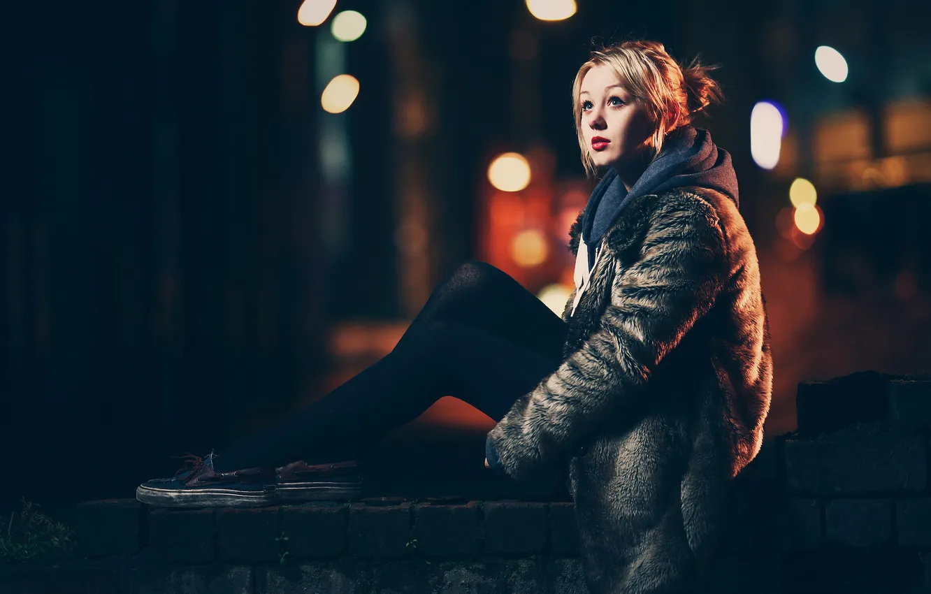 Photo wallpaper girl, night, glare, legs, sitting, looks, coat