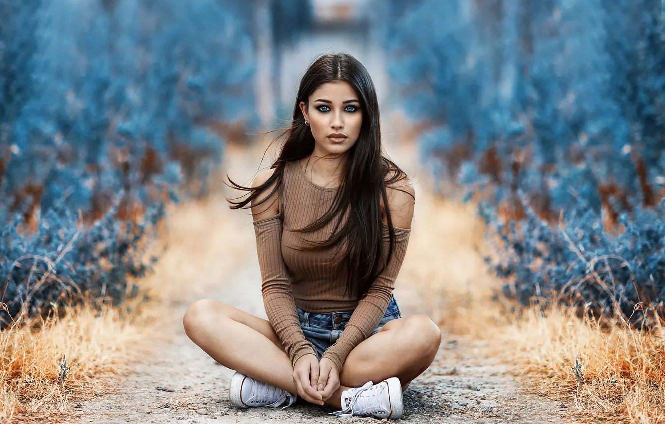 Photo wallpaper blue eyes, women, sitting, sneakers, tanned, depth of field, legs crossed, jean shorts