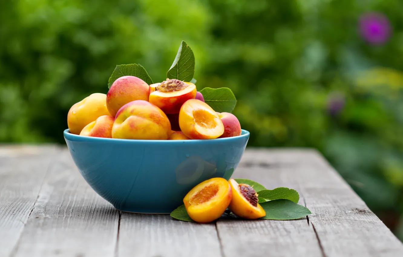 Photo wallpaper nature, table, bowl, peaches, halves, bokeh