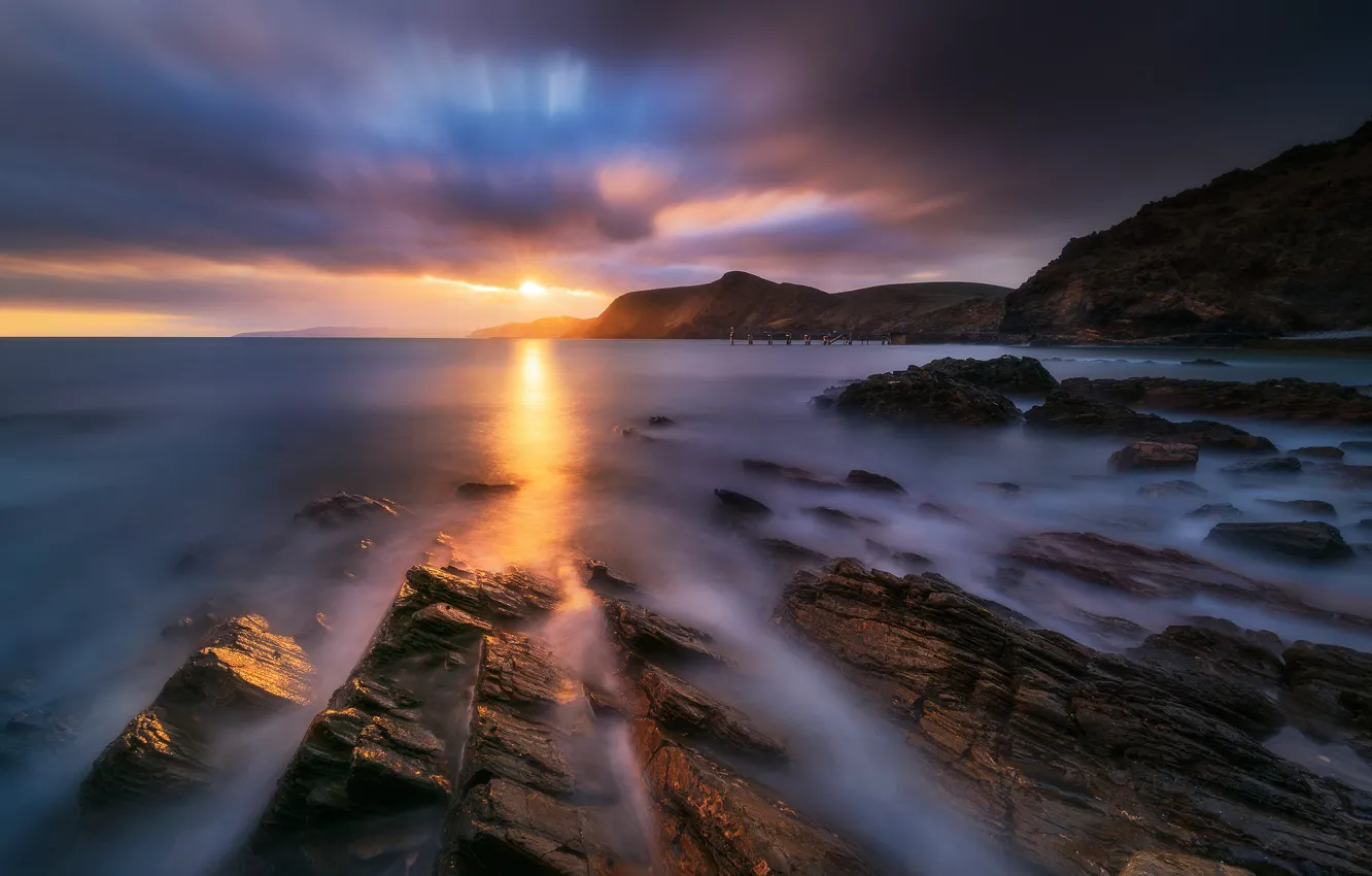 Photo wallpaper sea, clouds, light, sunset, mountains, clouds, stones, rocks