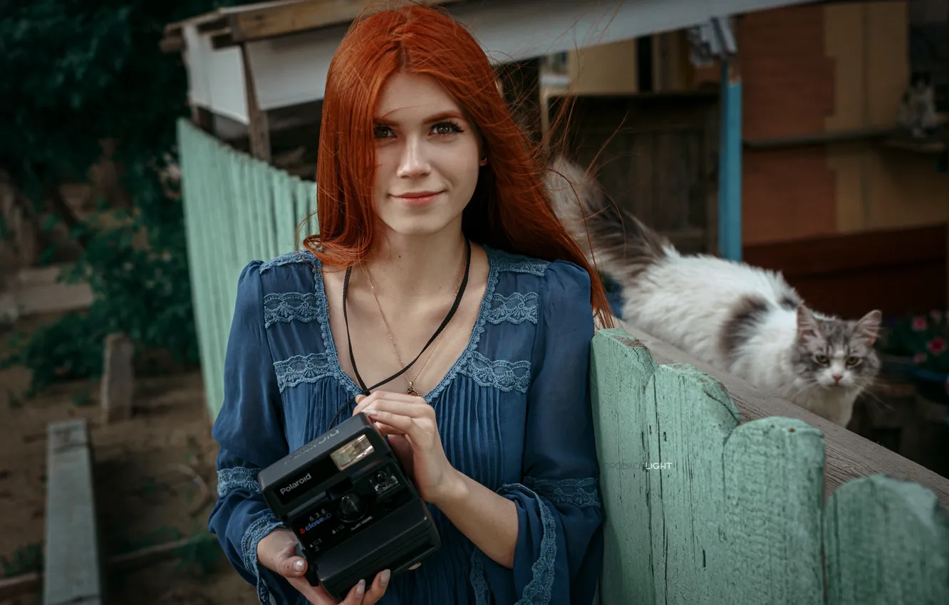 Photo wallpaper cat, look, girl, face, the fence, the camera, red, redhead