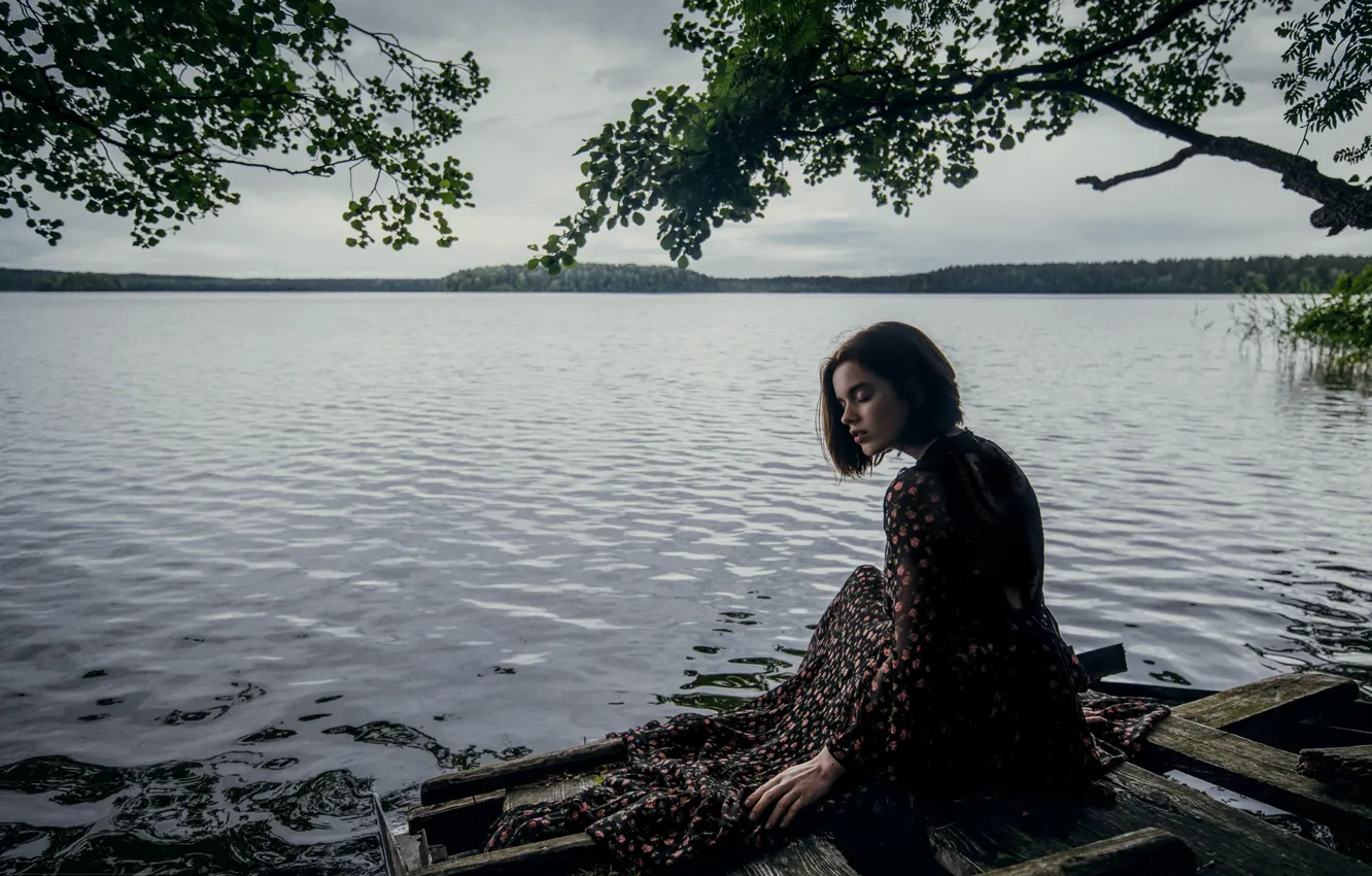 Photo wallpaper girl, lake, overcast, shore, sitting, long dress