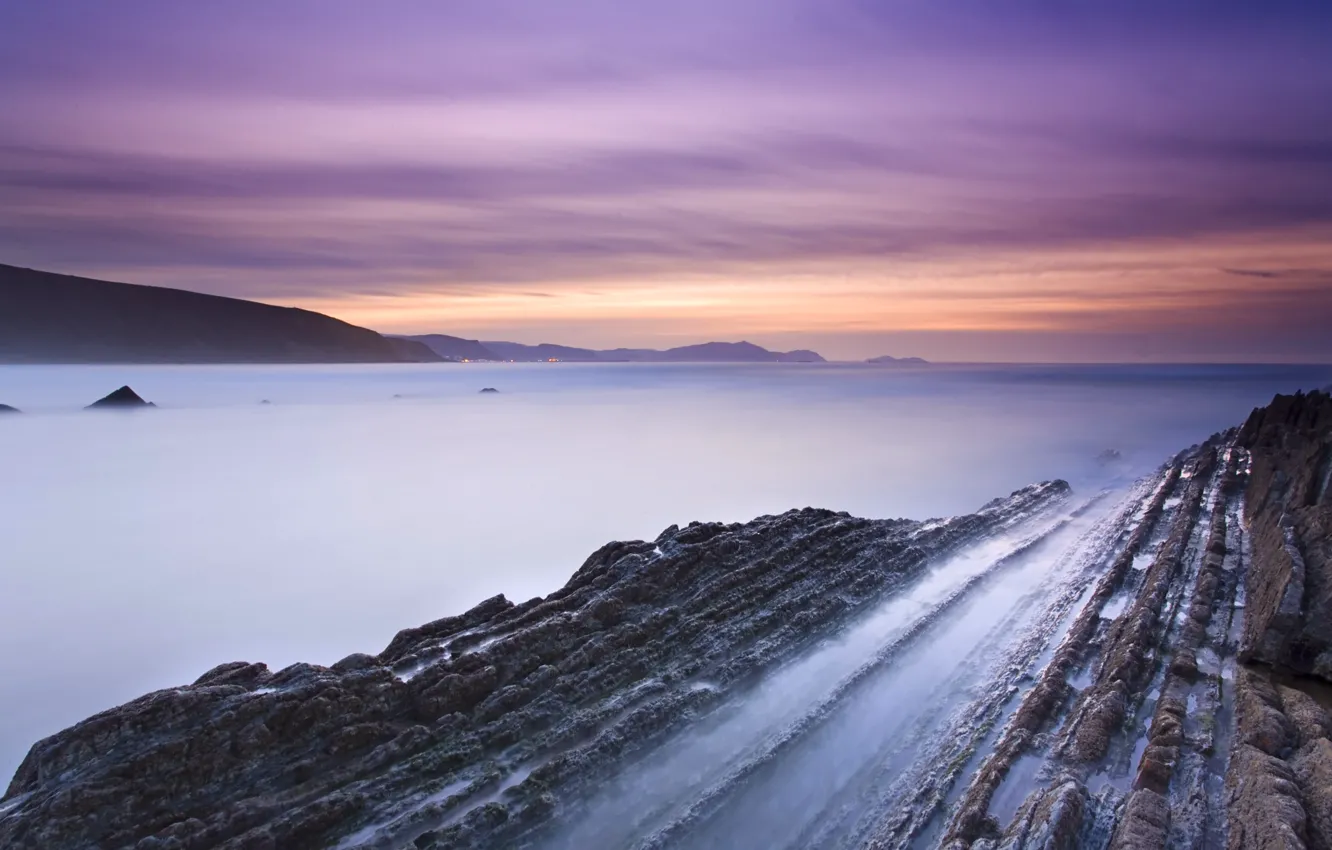 Photo wallpaper rocks, shore, the evening, Bay, Spain, tide, lilac sky, orange sunset