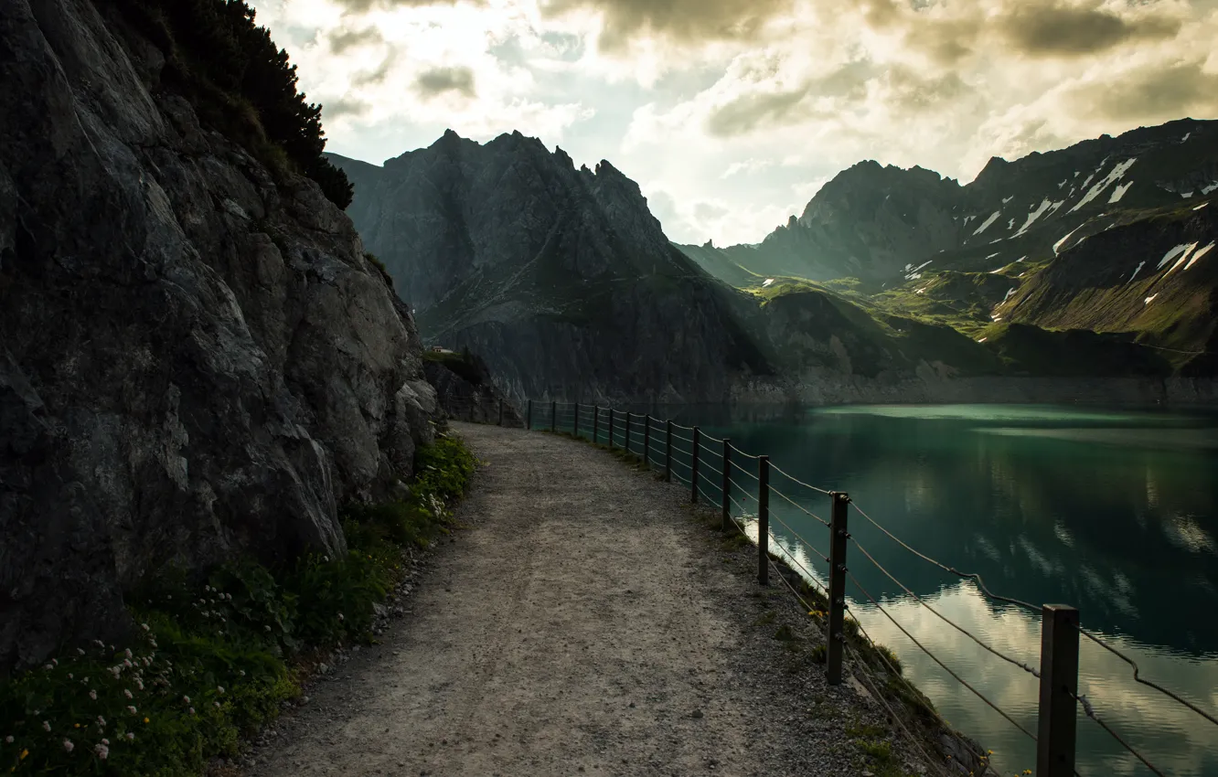 Photo wallpaper road, clouds, light, mountains, shore, tops, the fence, the fence