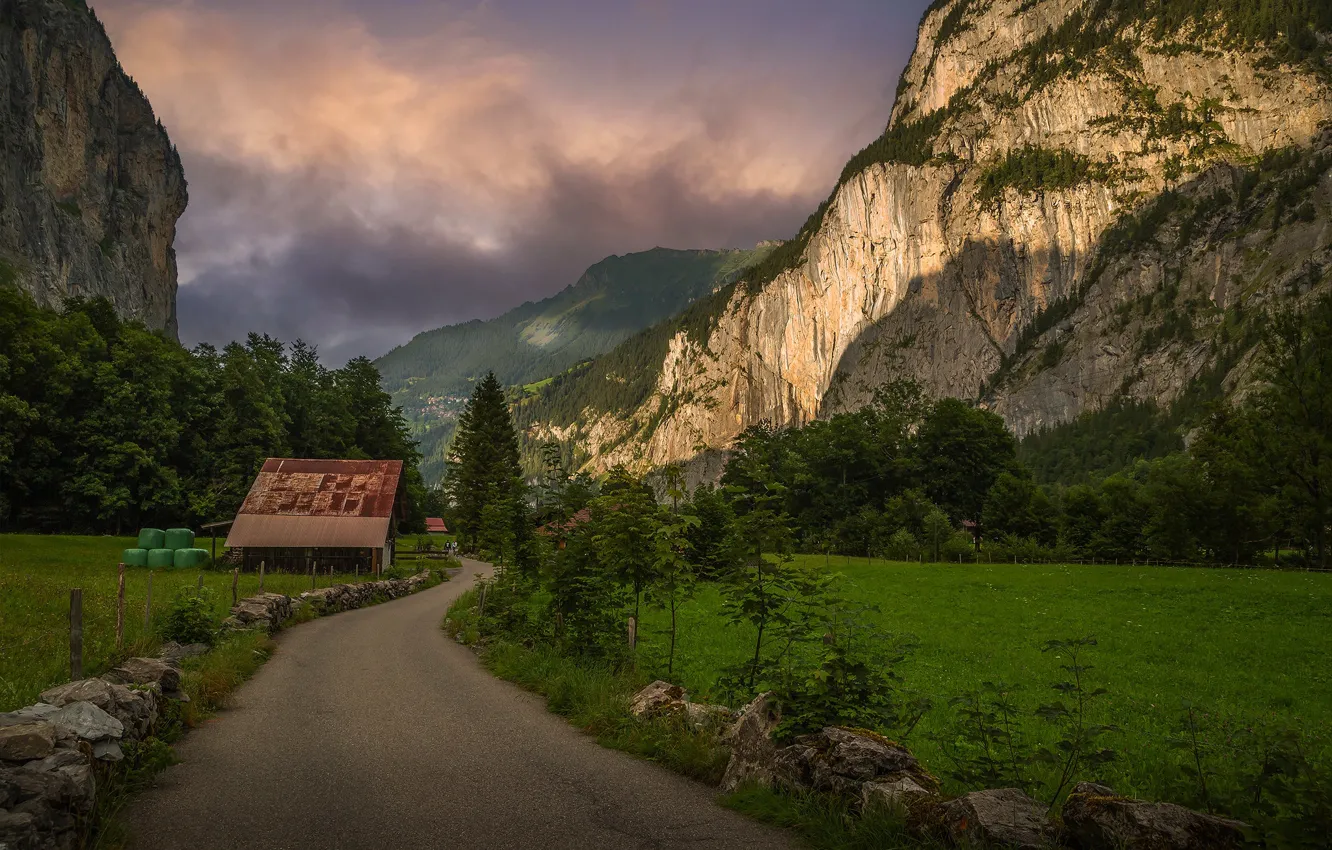 Photo wallpaper road, field, forest, clouds, light, mountains, stones, rocks
