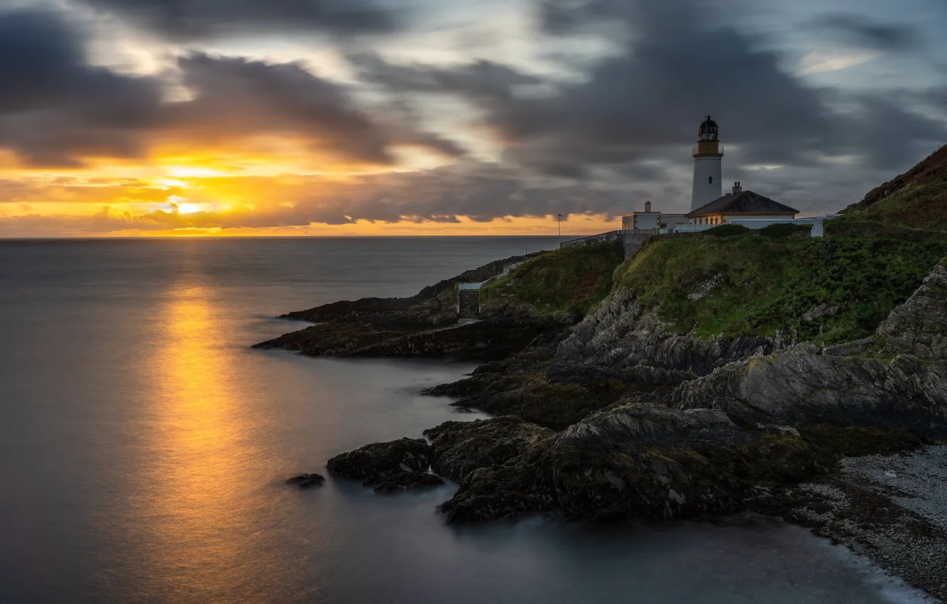 Photo wallpaper sea, the sky, the sun, clouds, sunset, stones, shore, lighthouse