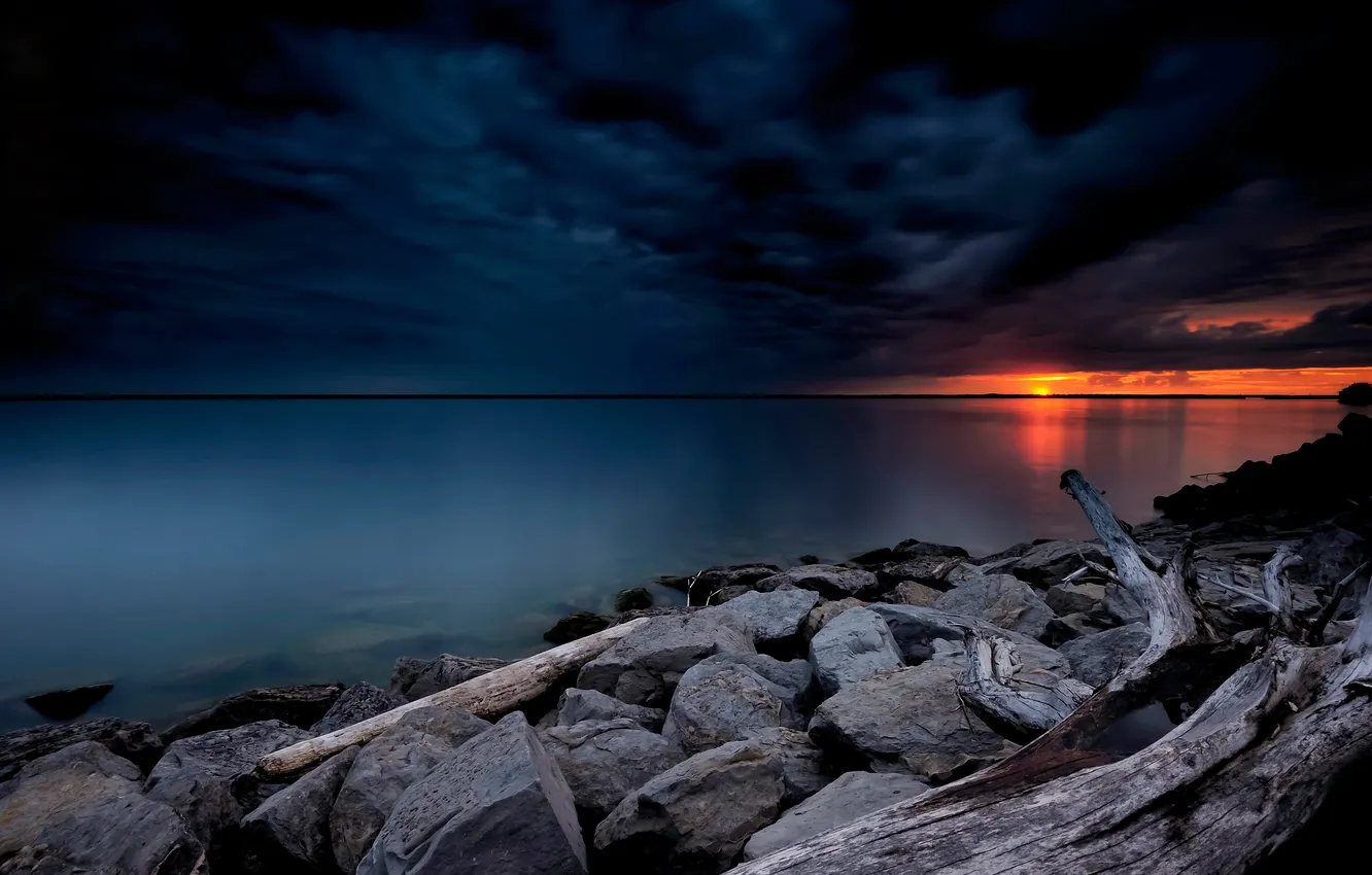 Photo wallpaper the sky, sunset, clouds, lake, stones, shore, glow, snag
