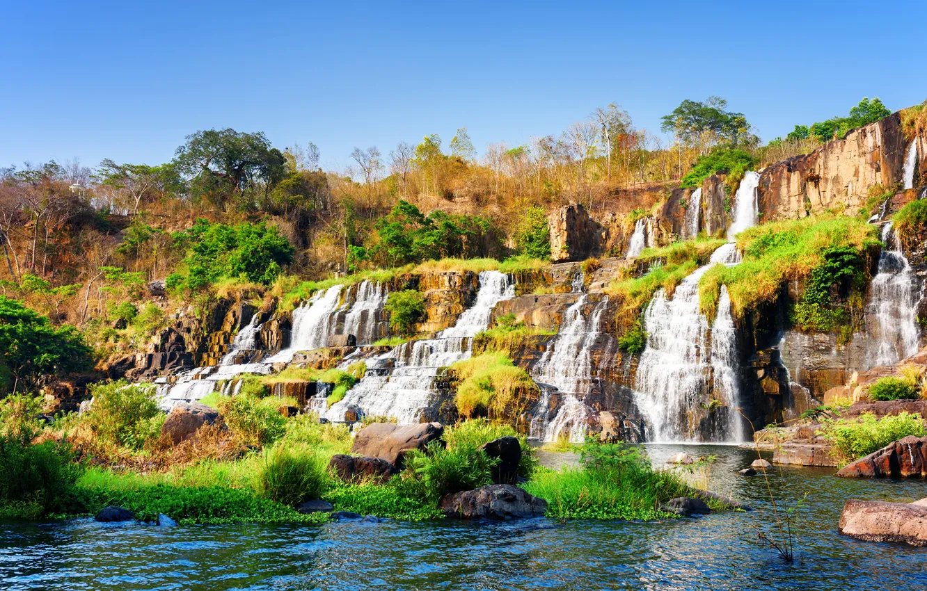 Photo wallpaper the sky, trees, stones, waterfall, Vietnam, Sunny, cascade, the bushes