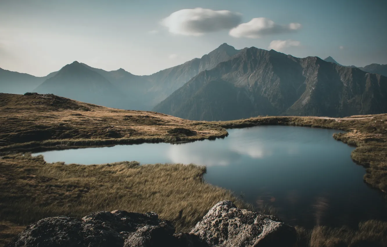 Photo wallpaper grass, clouds, mountains, fog, lake, shore, spring, haze