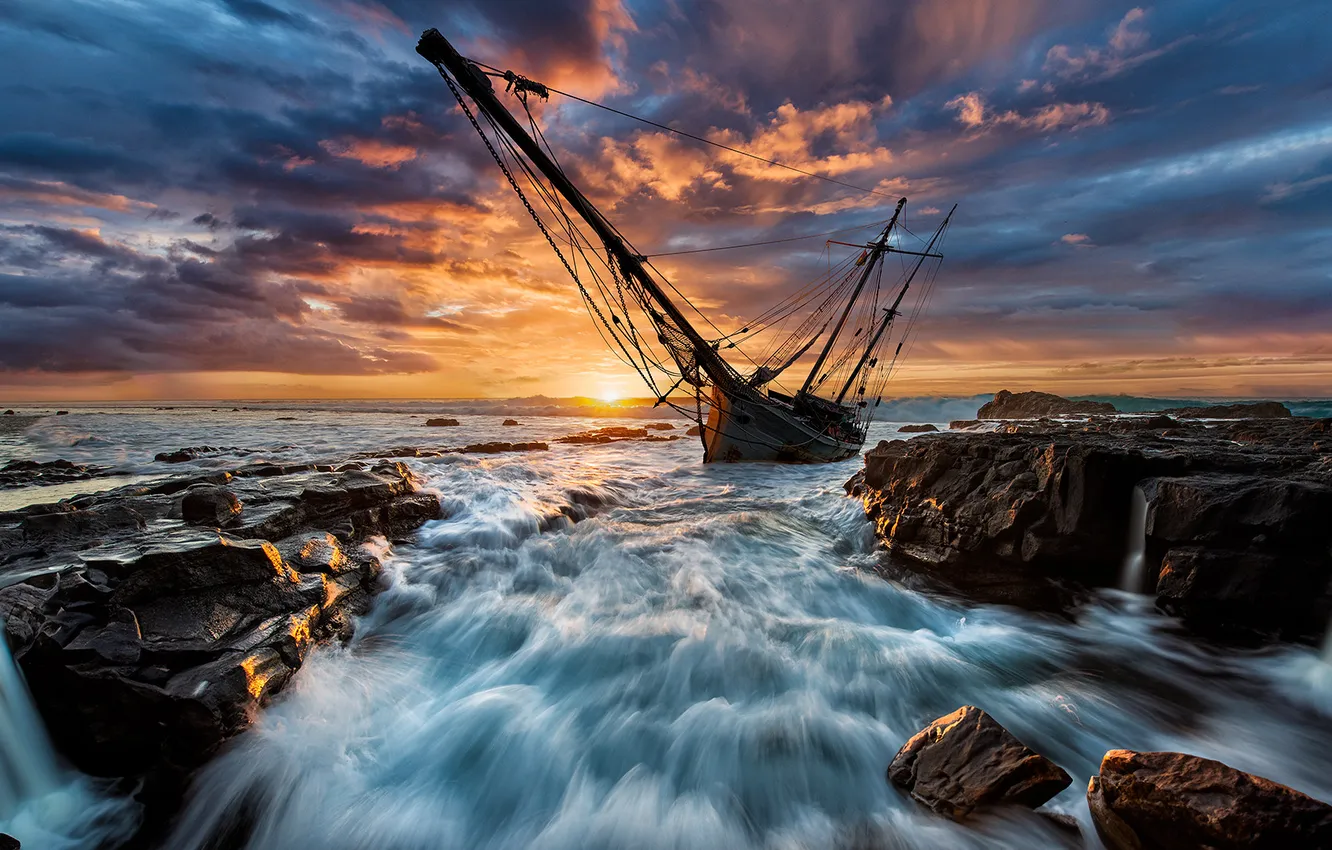 Photo wallpaper sea, wave, the sun, clouds, sunset, clouds, stones, rocks