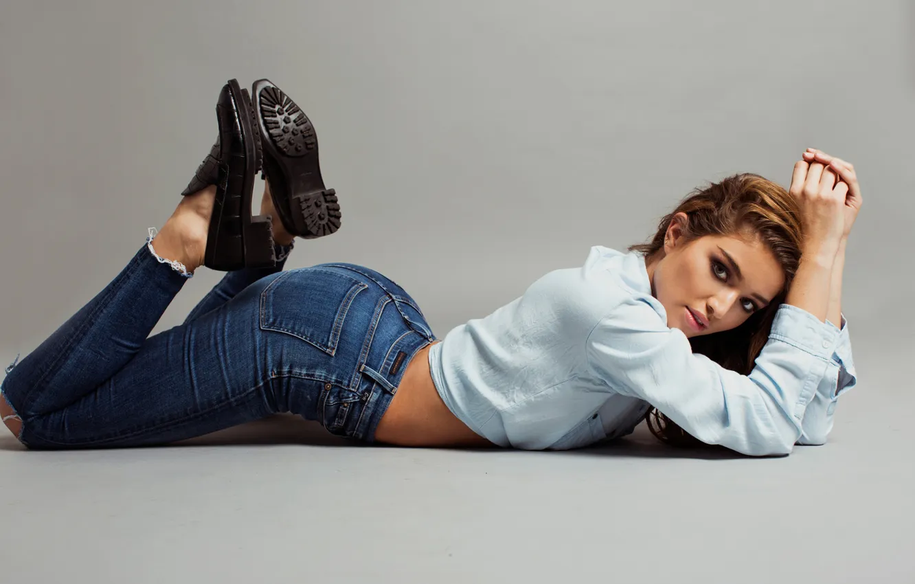 Photo wallpaper pose, jeans, grey background, beautiful girl, lying on the floor